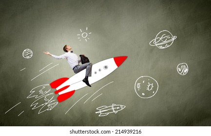 Young Businessman Flying In Sky On Drawn Rocket