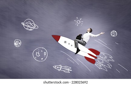 Young Businessman Flying In Sky On Drawn Rocket