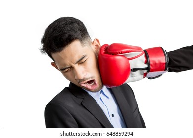 Young Businessman Getting Punch In His Face With Red Boxing Gloves On White Background. Business Competition Concept