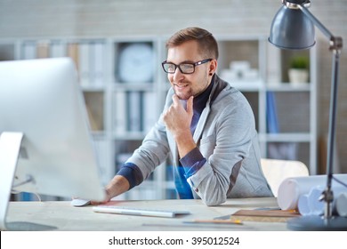 Young businessman in glasses working on computer - Shutterstock ID 395012524