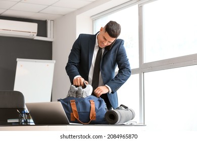 Young businessman going to go to gym after working day in office