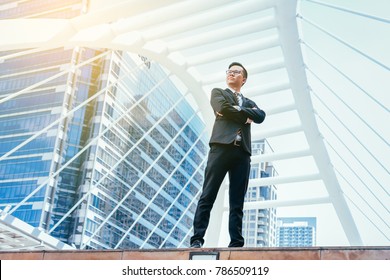 Young businessman handsome who standing in feeling commitment to doing business with cityscape background. - Shutterstock ID 786509119
