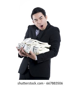 The young businessman happiness and holding a big pile of money on white background and copy space, concept success business