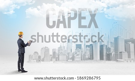 Young businessman with hard hat and CAPEX inscription, new business opportunity concept