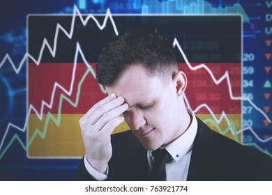 Young businessman having headache with declining finance graph and American flag in the trade stock - Powered by Shutterstock