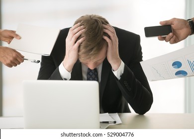 Young businessman hiding head, balancing between duties, juggling million things at once, ineffective employee management, supervising big company alone, preparing annual report, time to have vacation - Powered by Shutterstock