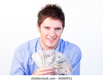 Young businessman holding dollars at the camera