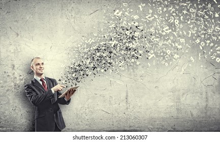 Young businessman holding tablet pc and letter flying in air