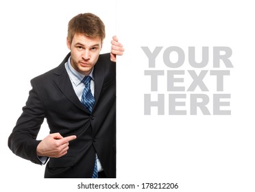 Young businessman holding a whiteboard. Concept - a demonstration of achievements in business, graphic ads. Isolated on white.