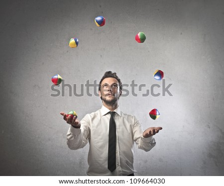Young businessman juggling