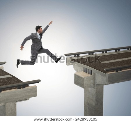 Young businessman jumping over the bridge