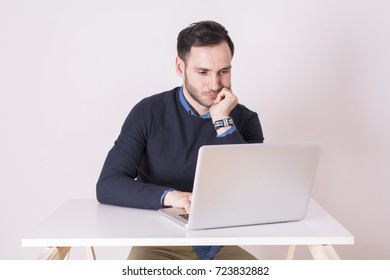 Young businessman with laptop. Bored expression - Shutterstock ID 723832882