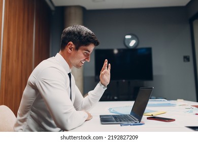 Young Businessman With Laptop At Table In Office. Video Conference Call Web Cam Meeting.