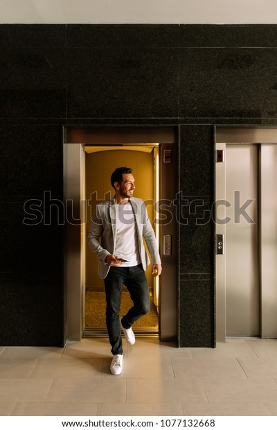 young businessman leaving the elevator in a\
finance building. business\
concept