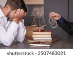 Young businessman in legal consultation with criminal lawyer, jail, financial crime, handcuffed