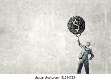 Young Businessman Lifts Up Heavy Weight With Dollar Sign