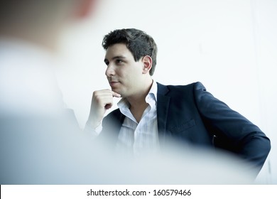Young Businessman Listening In Business Meeting