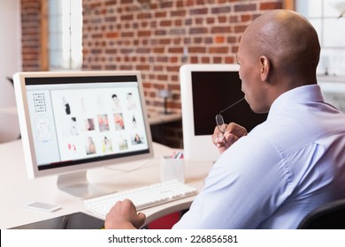 Young Businessman Looking At Computer Monitor In Office