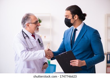 Young businessman meeting with old doctor - Powered by Shutterstock