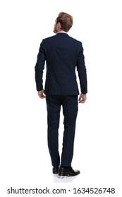 Young Businessman In Navy Blue Suit Looking Up And Dreaming, Walking Isolated On White Background, Full Body