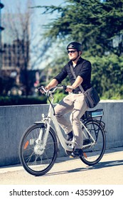 Young Businessman On Electric Bicycle