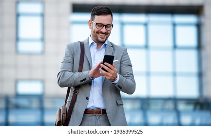 Young businessman on the way to the office searching information on the internet with smartphone. Business, education, lifestyle concept - Shutterstock ID 1936399525