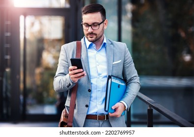 Young businessman on the way to the office searching information on the internet with smartphone. Business, education, lifestyle concept - Shutterstock ID 2202769957