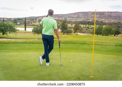 Young Businessman Playing Golf And Answering A Work Call With The Phone