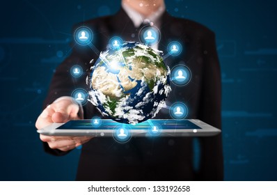 Young businessman presenting 3d earth globe in tablet elements of this image furnished by NASA