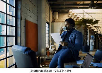 Young businessman reading paperwork document in office - Powered by Shutterstock