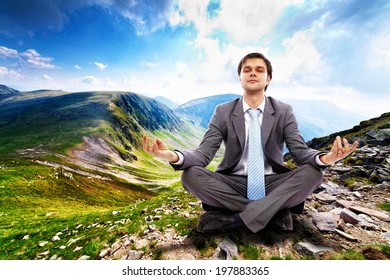 Young businessman relaxing in the mountains, away from the city life and business meetings - Powered by Shutterstock