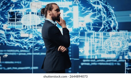 Young businessman reviews artificial intelligence neural networks on dashboard, using high tech automation tools for coding, analytics and deep learning for strategic development. Camera A.