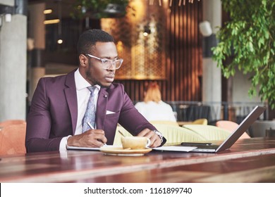 A young businessman signs a contract in a conference room. - Shutterstock ID 1161899740
