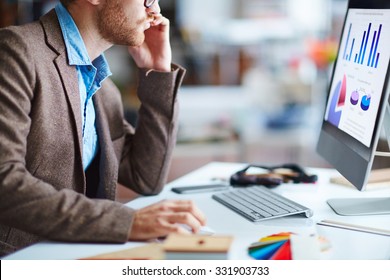 Young Businessman Sitting In Front Of Pc In Office