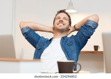 Young businessman sitting with hands behind head in office
 - Powered by Shutterstock