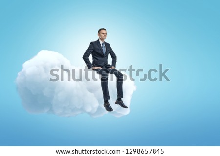 A young businessman sitting on a white fluffy cloud in the blue sky with lots of copy space left. Dream big. Business and strategy. Forethought and vision.