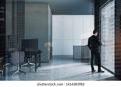 Young businessman with smartphone standing in modern kitchen interior with gray and white walls, gray countertop and dining table with chairs. Real estate market concept. Toned image double exposure - Shutterstock ID 1414383983