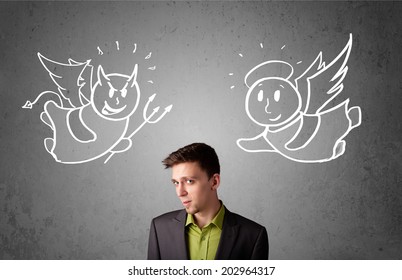 Young businessman standing between the angel and the devil drawings