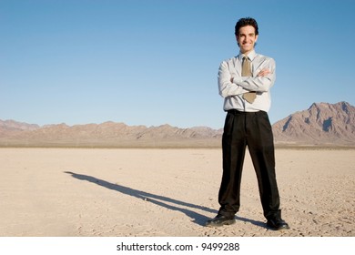 Young businessman standing in the desert