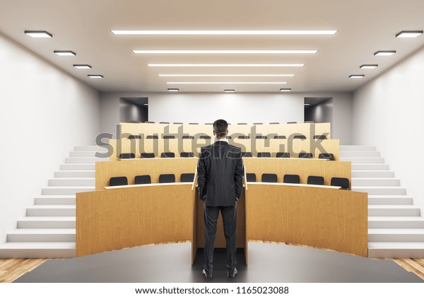 Young Businessman Standing Modern Auditorium Interior Stock Photo