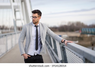 Young Businessman Standing On The Bridge. Yuppie Outdoors Relaxing