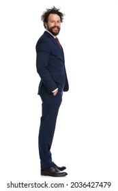 Young Businessman Standing One Way And Looking The Other Against White Background 