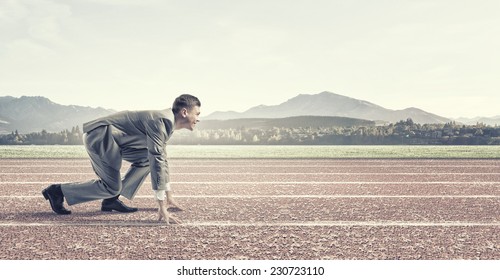 Young Businessman Standing In Start Pose Ready To Run