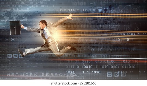 Young Businessman In Suit Running At Full Pelt