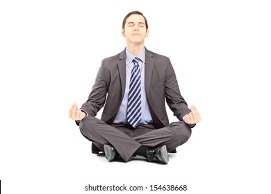 Young Businessman In Suit Sitting On A Floor And Meditating Isolated On White Background