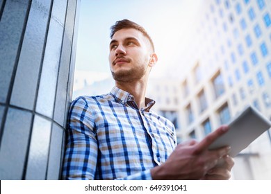 Young businessman with tablet outdoors