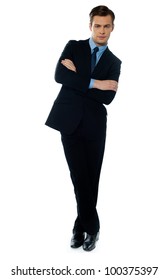 Young businessman tilting and smiling against white background