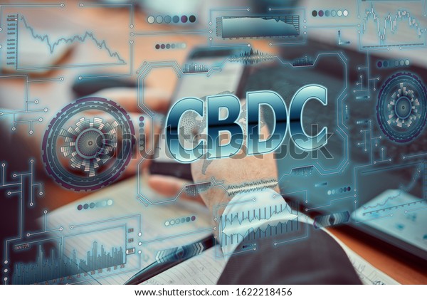 A young businessman uses a futuristic smartphone with the latest holographic technology of augmented reality with the inscription "CBDC". Central bank digital currency concept