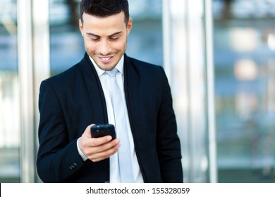 Young businessman using his smartphone - Shutterstock ID 155328059