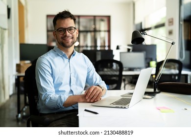 Young businessman using laptop in his office. Handsome man working on the project. - Shutterstock ID 2130488819